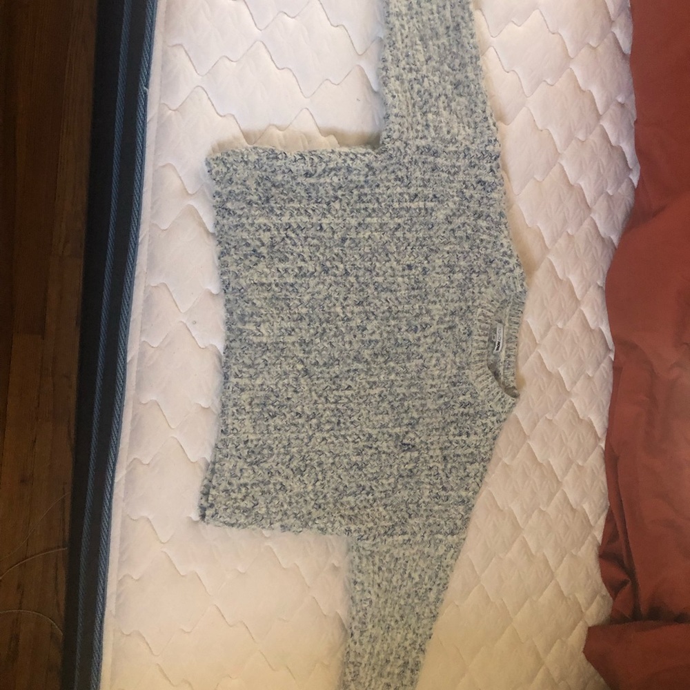A white and blue threaded design knit sweater.